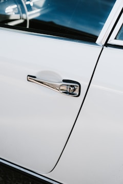 Close-up of a luxury car door perfectly restored after hail damage.