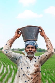 a man is holding a bucket over his head