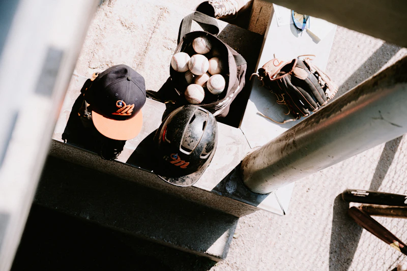 Baseball cap and glove resting on the ground