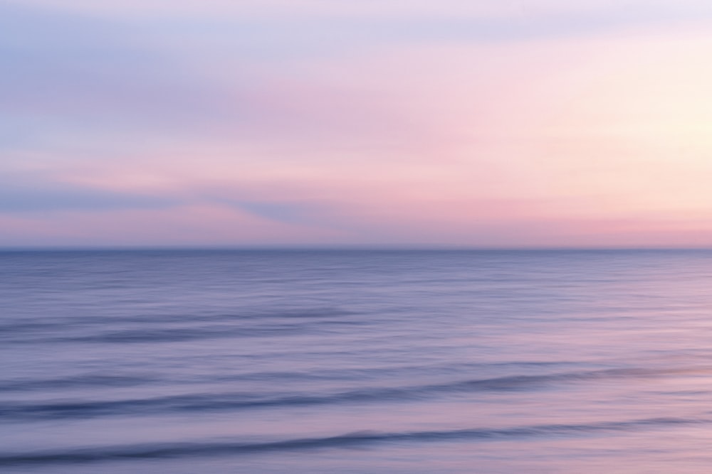 a blurry photo of the ocean at sunset