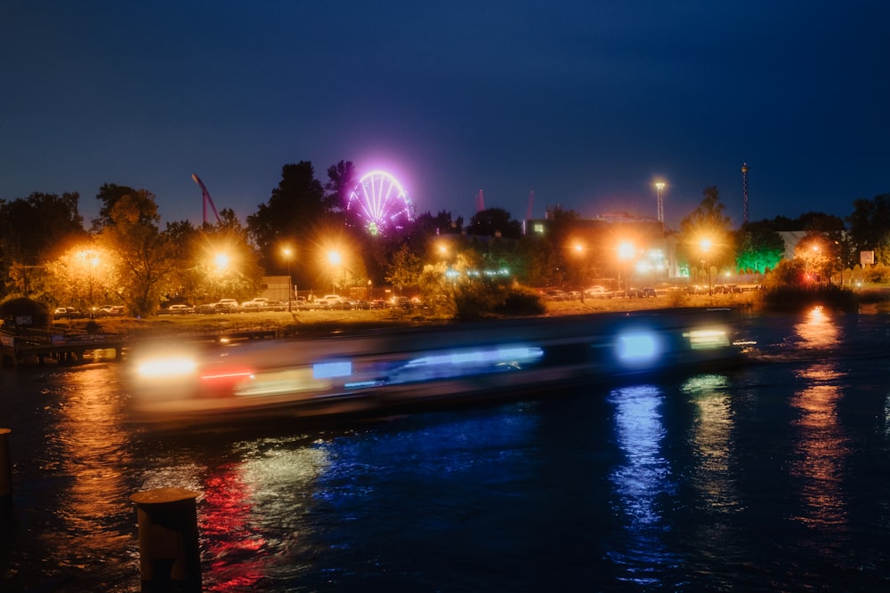 a boat traveling down a river at night