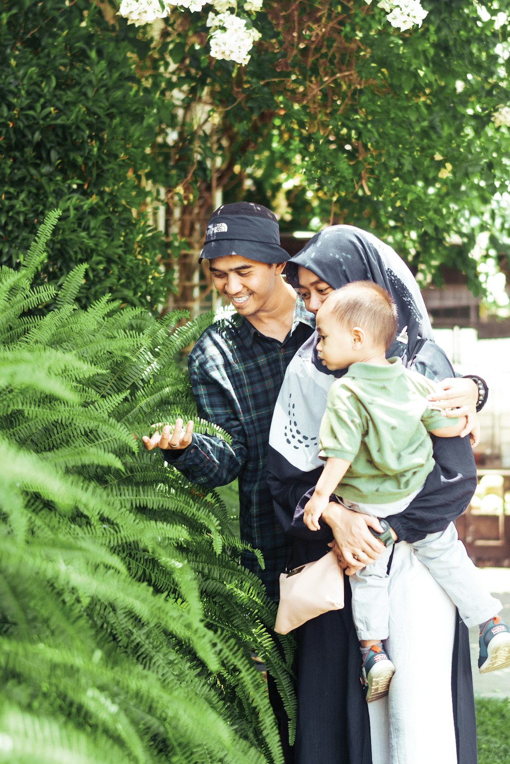 a couple of people that are holding a baby