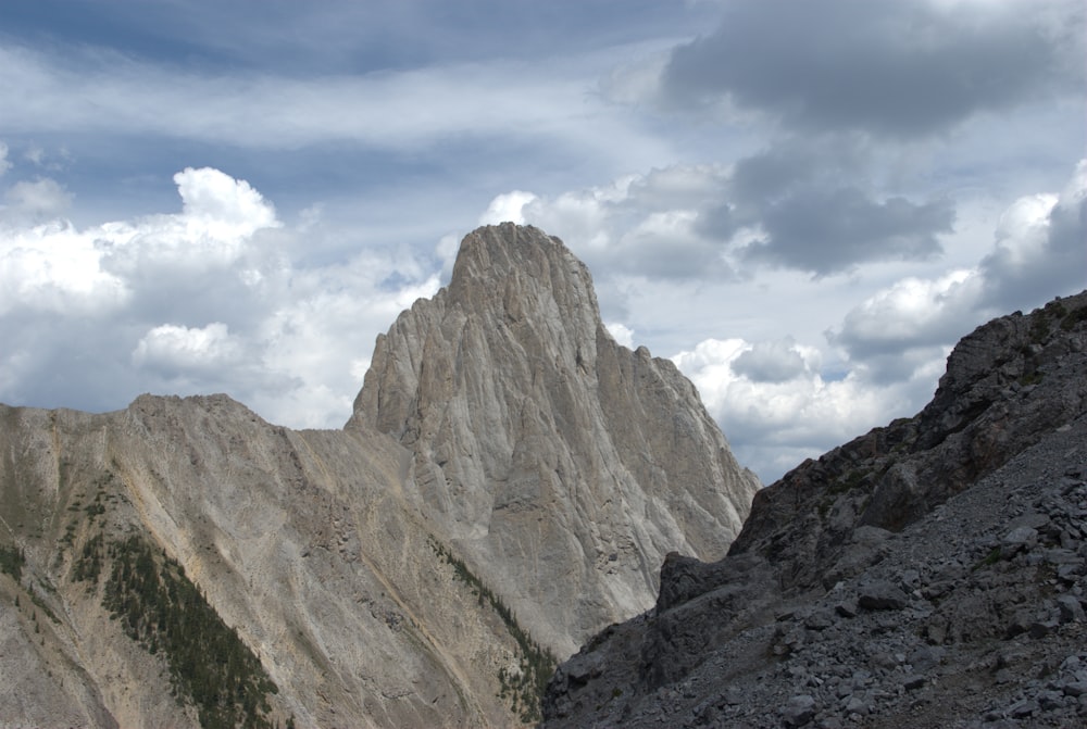 a mountain range with a few clouds in the sky