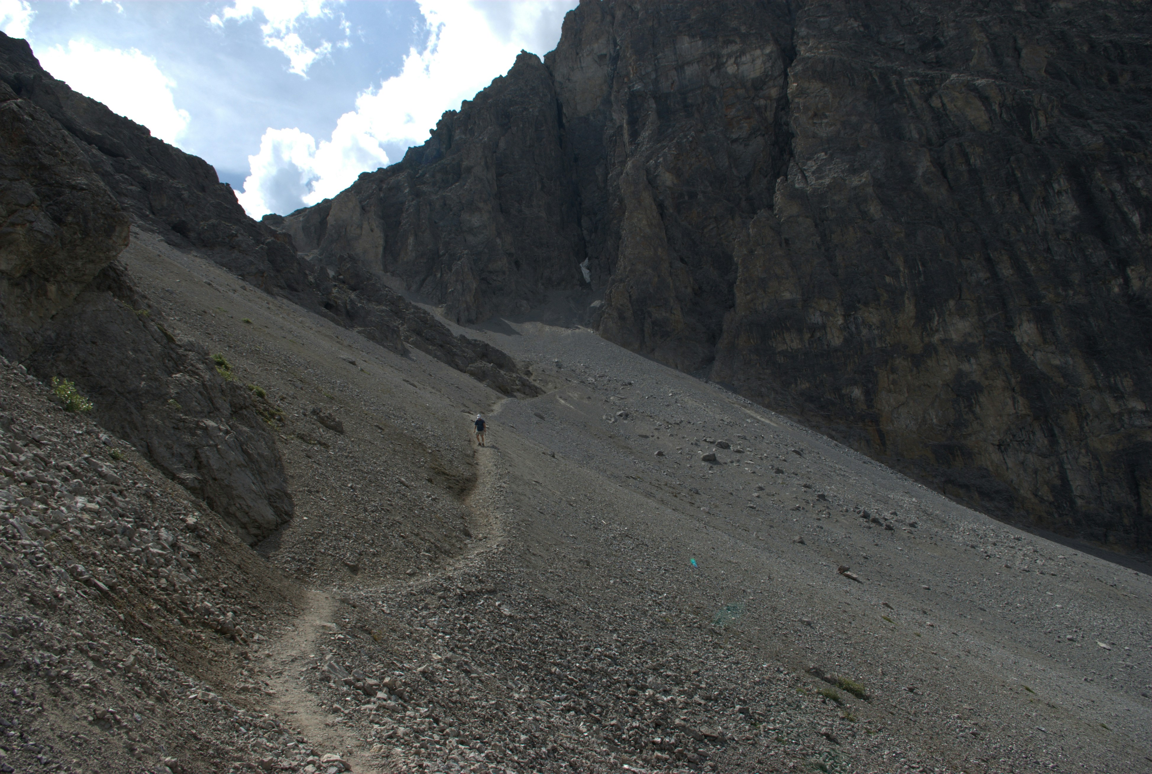 a person hiking up a rocky mountain side