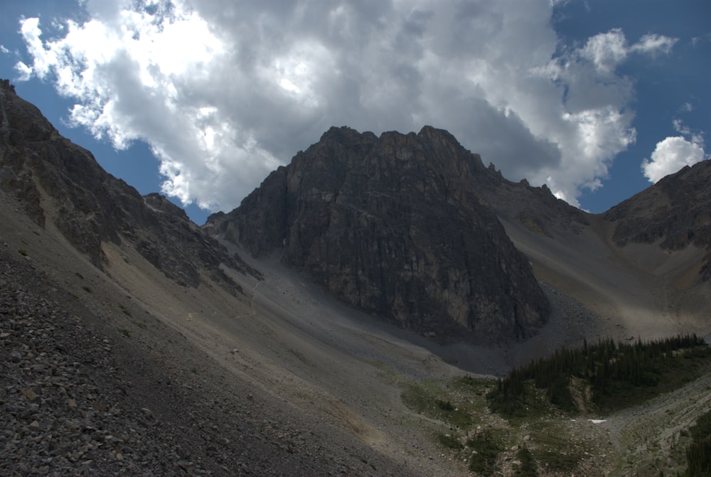 a view of a mountain range with clouds in the sky