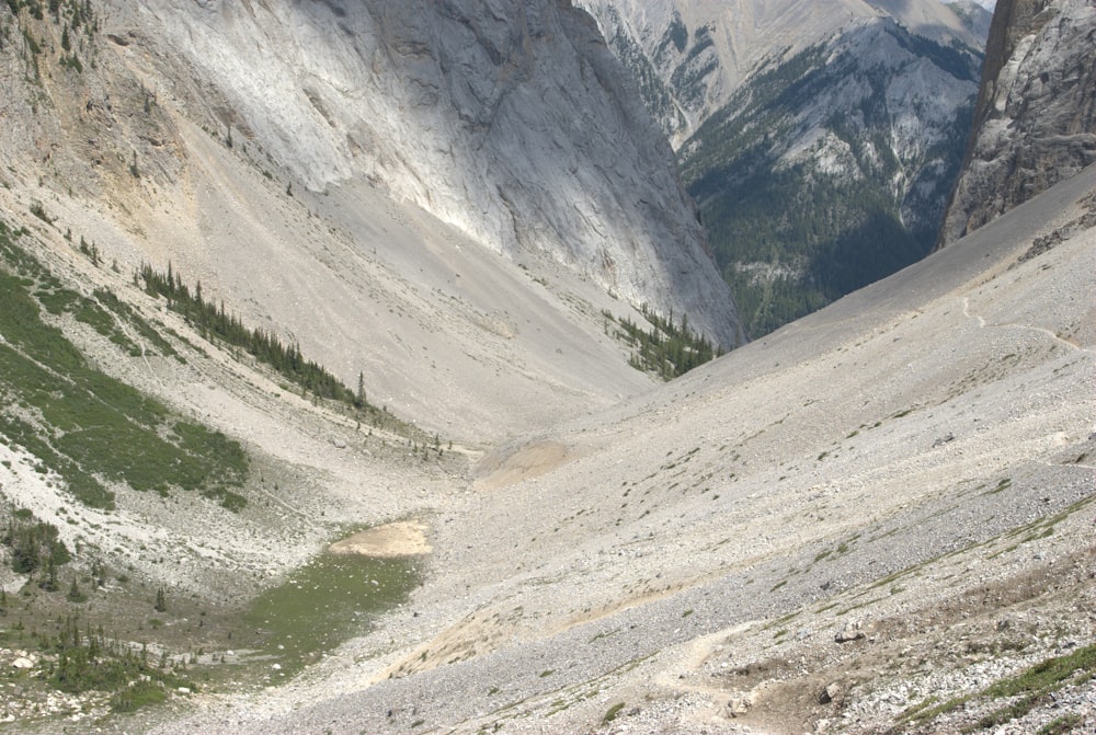 a man riding a horse down a mountain side