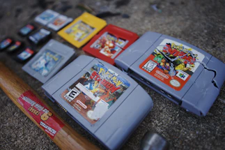Close-up of a vintage Nintendo 64 cartridge with a custom label on a factory workbench.