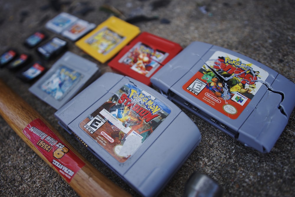 a group of nintendo games sitting next to a baseball bat