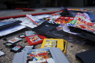 Sample retail boxes and manuals displayed alongside custom GBA cartridges.