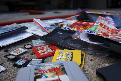 Sample retail boxes and manuals displayed alongside custom GBA cartridges.