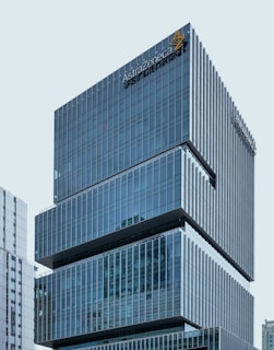 Photo of a modern office building with the Astra Construction logo visible on the facade.