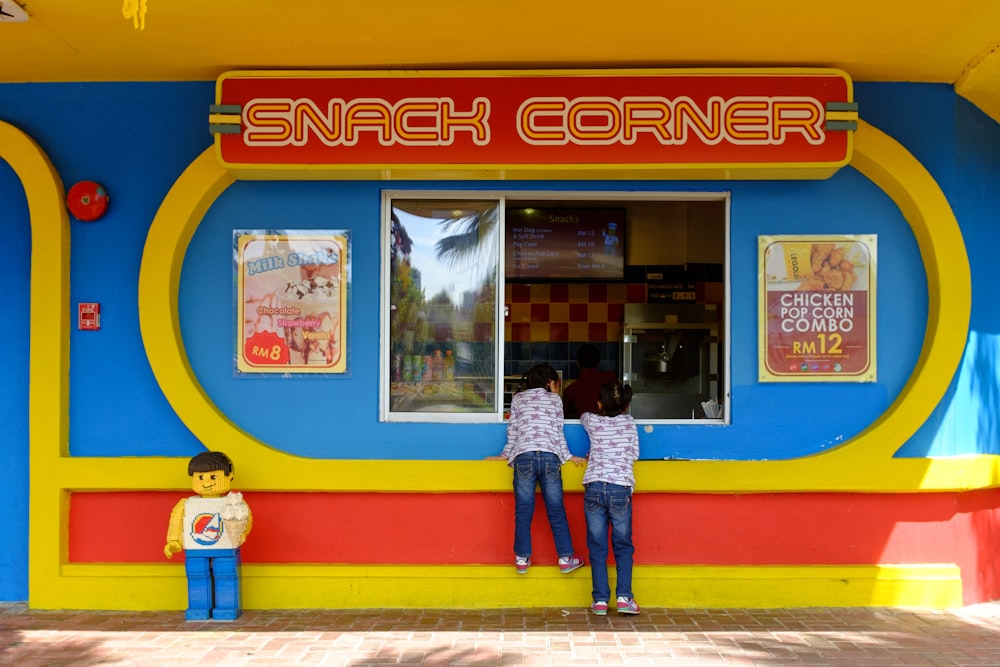 a couple of people that are standing in front of a store