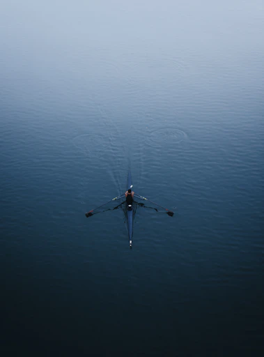 a person rowing a boat on a body of water