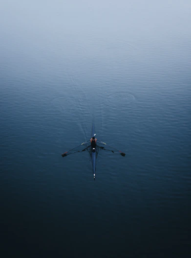 a person rowing a boat on a body of water
