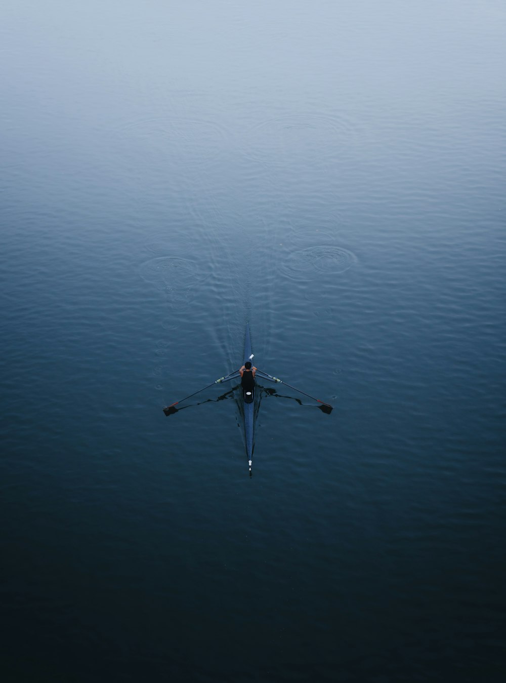 a person rowing a boat on a body of water