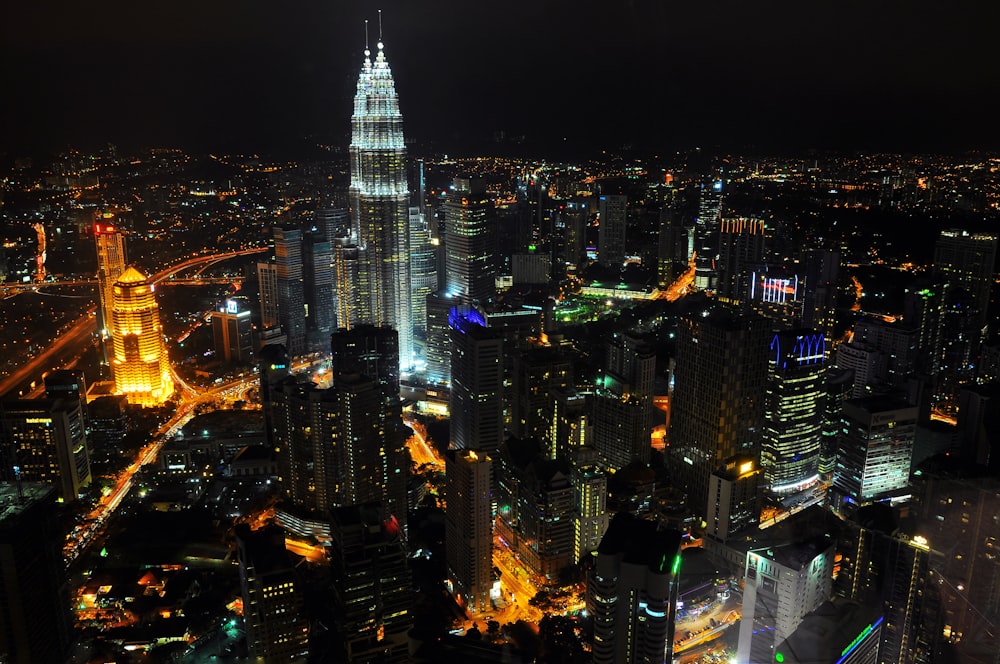 a view of a city at night from the top of a skyscraper