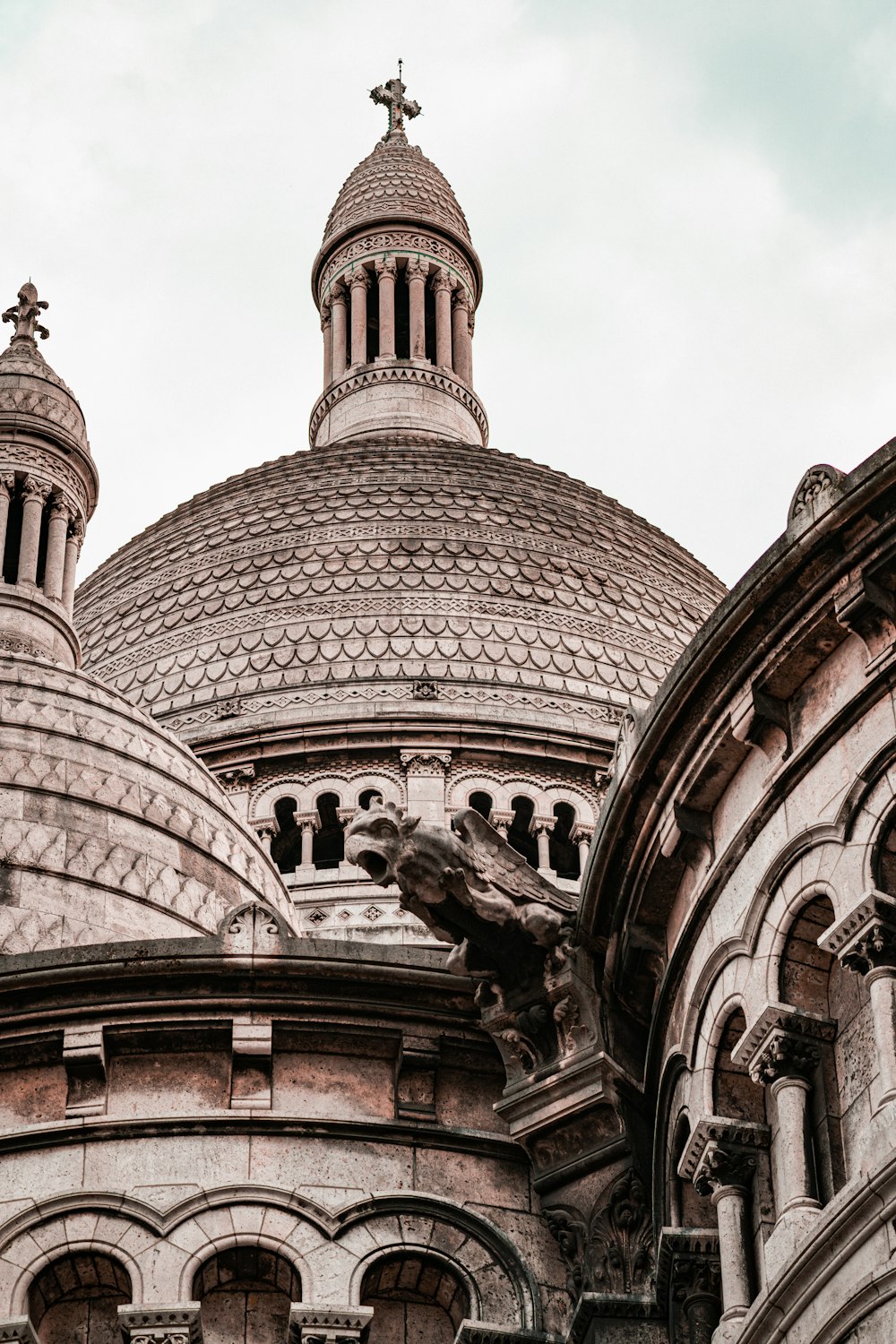 a building with a large dome and a bird statue on top of it