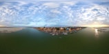 A panoramic view of the delta’s waterways with boats cruising and birds flying overhead.