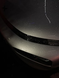Glossy car surface with ceramic coating showing water beading off effortlessly.