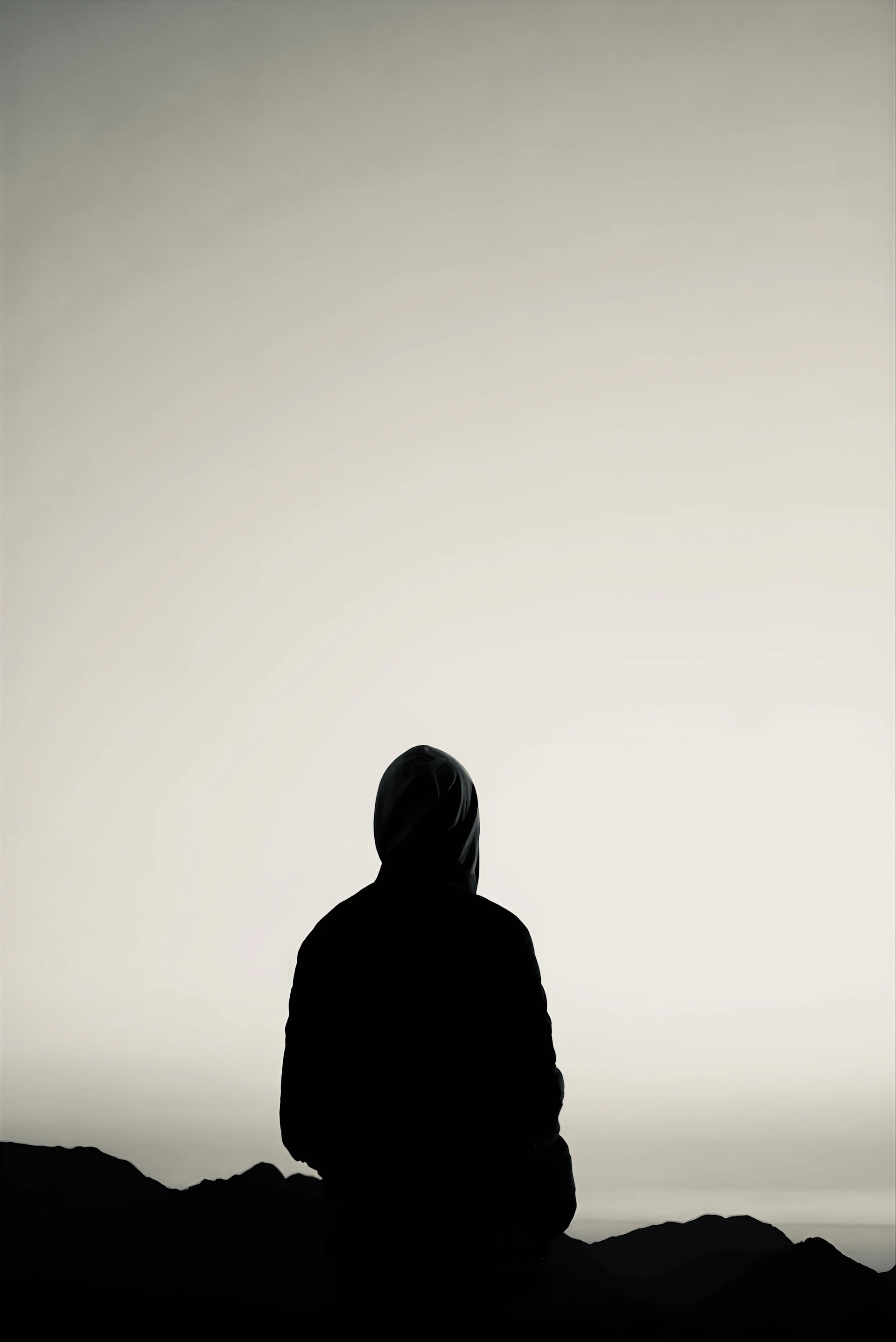 An intimate portrait of a solitary figure wrapped in a flowing cloak, standing beneath a twilight sky filled with stars.