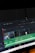 A computer screen displaying video editing software with a timeline view. The timeline includes clips, audio tracks, and a toolbar with options for cutting and editing. The background is dark, emphasizing the software interface.