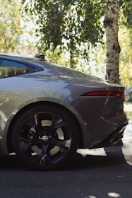 A freshly replaced rear window shining on a parked car under natural light.