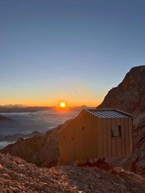 A welcoming Colorado mountain cabin with a sunset backdrop, symbolizing short-term rental opportunities.