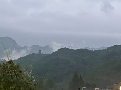 An atmospheric scene depicting a blend of myth and reality in a Southeast Asian landscape.