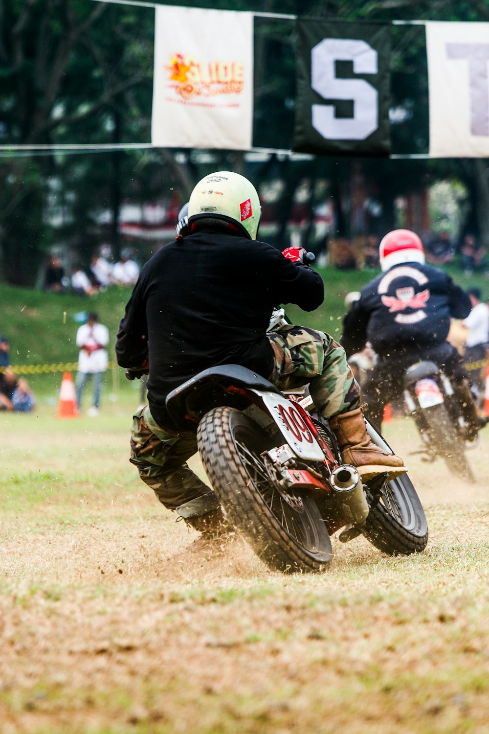 a group of people riding dirt bikes on a field