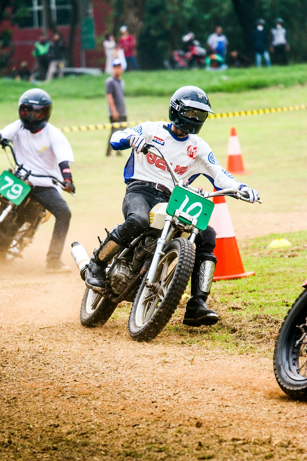 a man riding a dirt bike on top of a dirt field