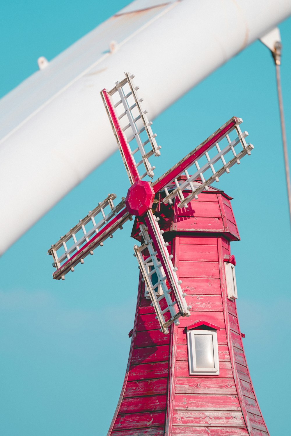 a windmill with a red roof and a white roof