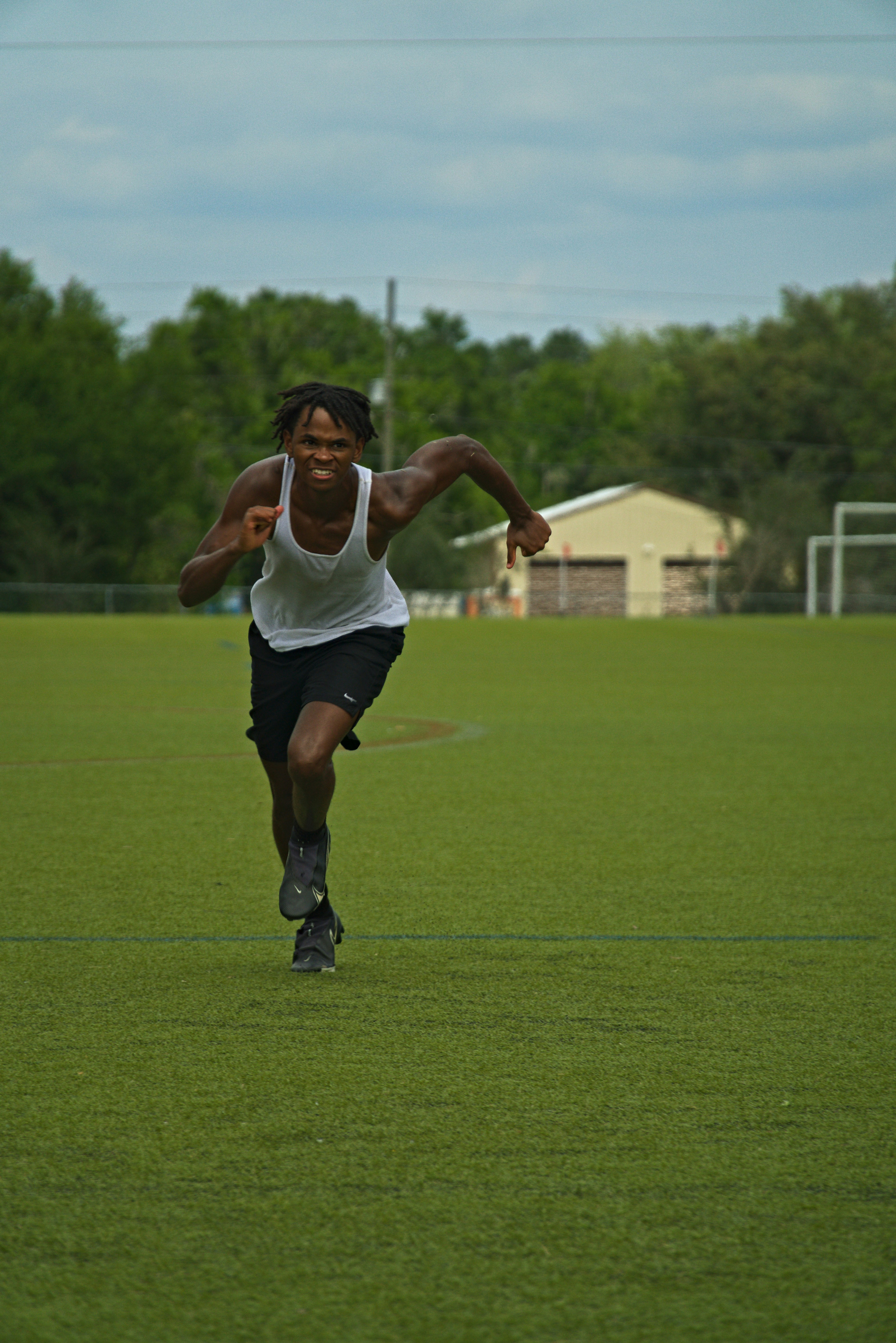 a man running across a field with a frisbee