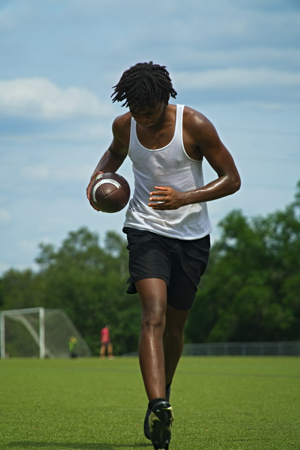 a man running with a football in his hand