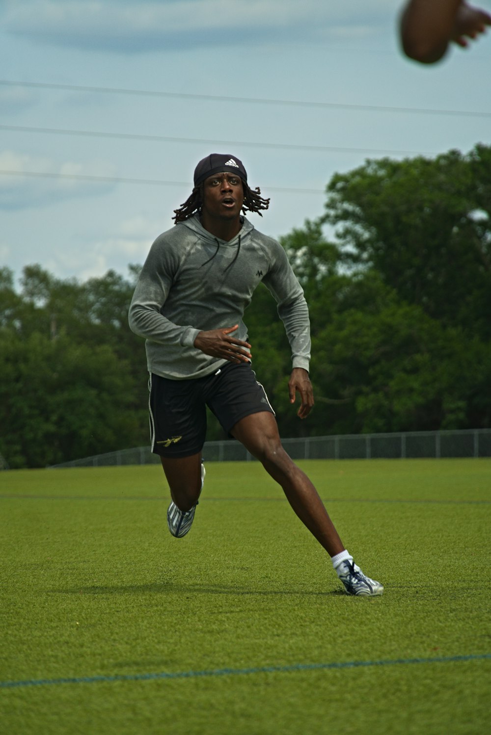 a man is running with a frisbee in his hand