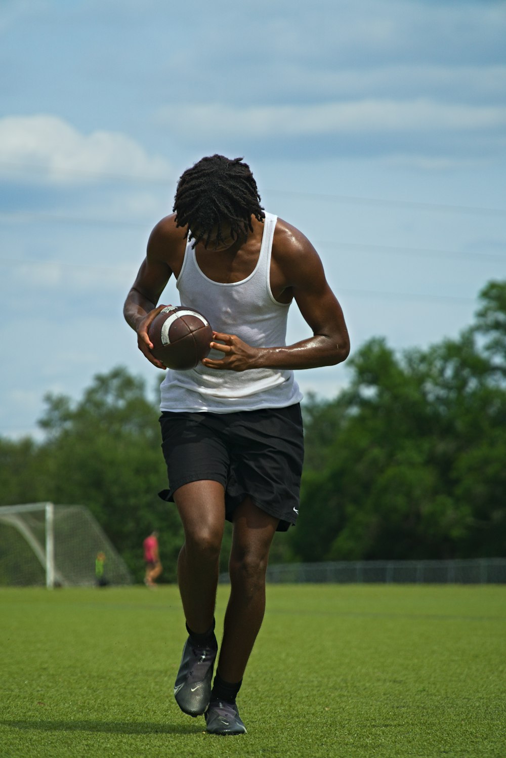 a man running with a football in his hand