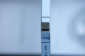 Close-up of a sleek, silver anodized aluminium sheet reflecting soft light.