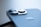 Close-up view of a smartphone with a focus on the camera lenses. The device features sleek, metallic design elements and an Apple logo.