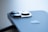 Close-up view of a smartphone with a focus on the camera lenses. The device features sleek, metallic design elements and an Apple logo.