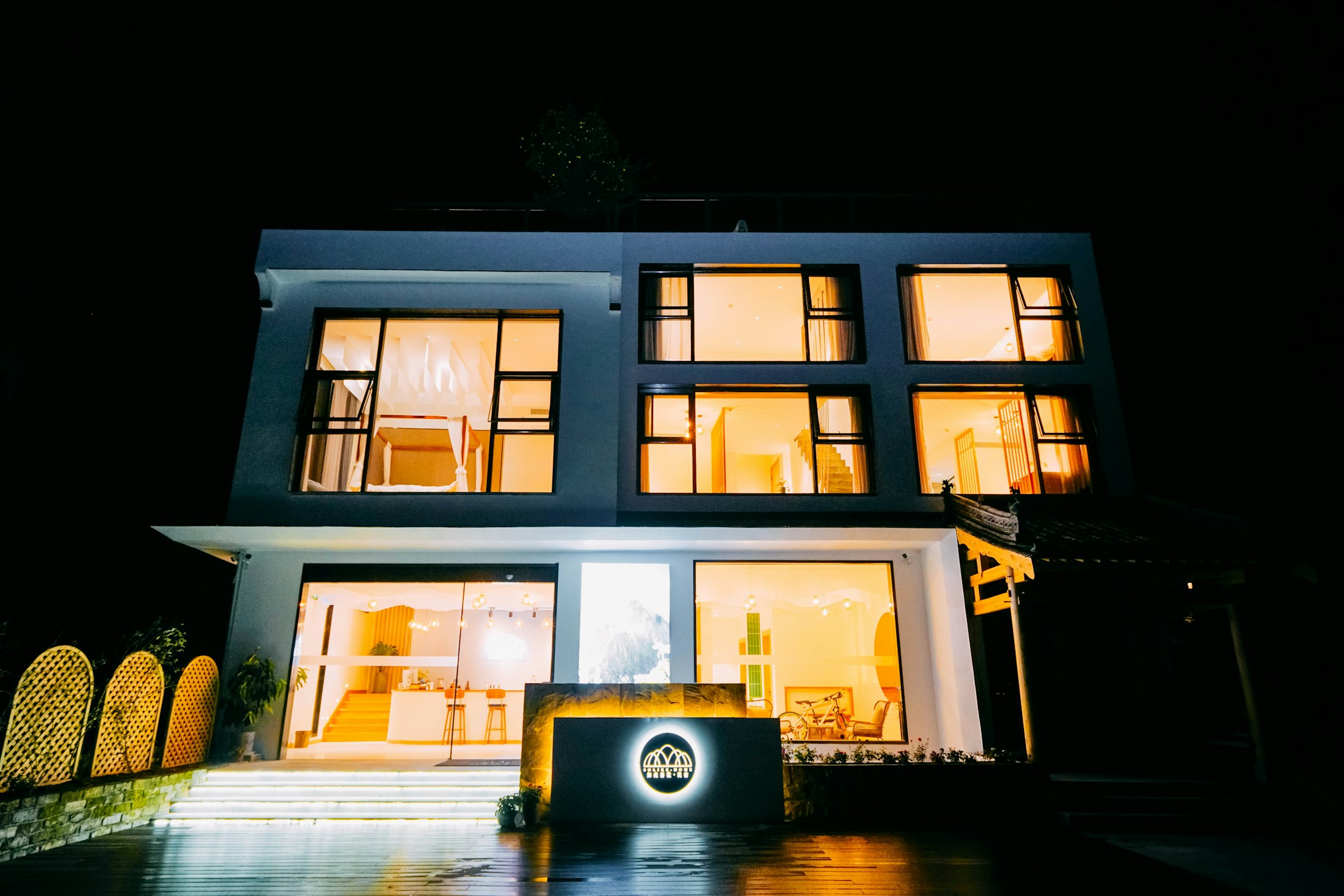 Modern house glowing with warm light at night