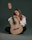 Focused woman practicing guitar with sheet music in a stylish studio