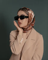 a woman wearing sunglasses and a scarf