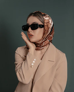 a woman wearing sunglasses and a scarf