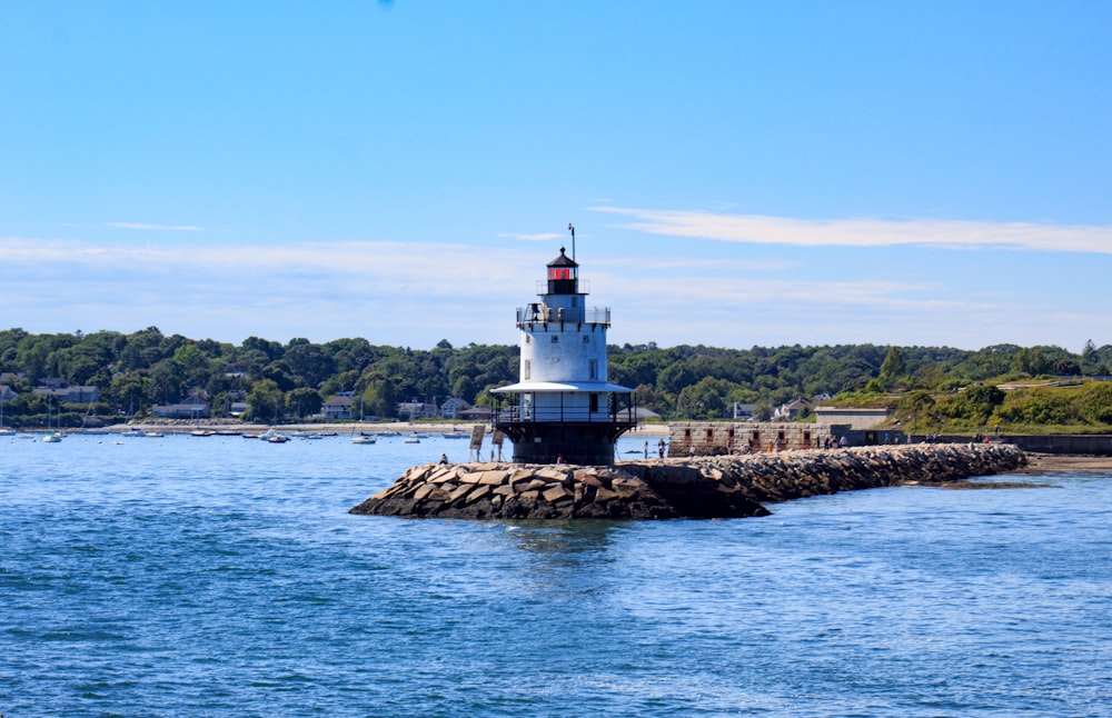 a light house sitting on top of a pier