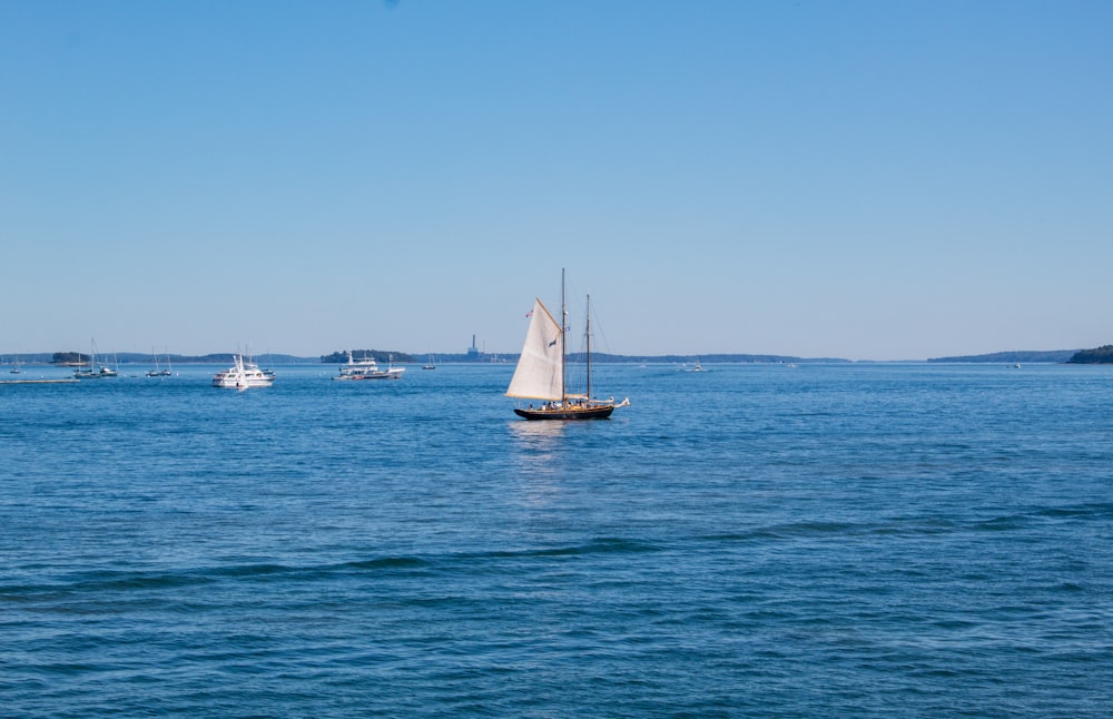 a group of boats floating on top of a large body of water