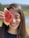 Portrait of a happy Iraqi farmer holding a watermelon in a lush field.