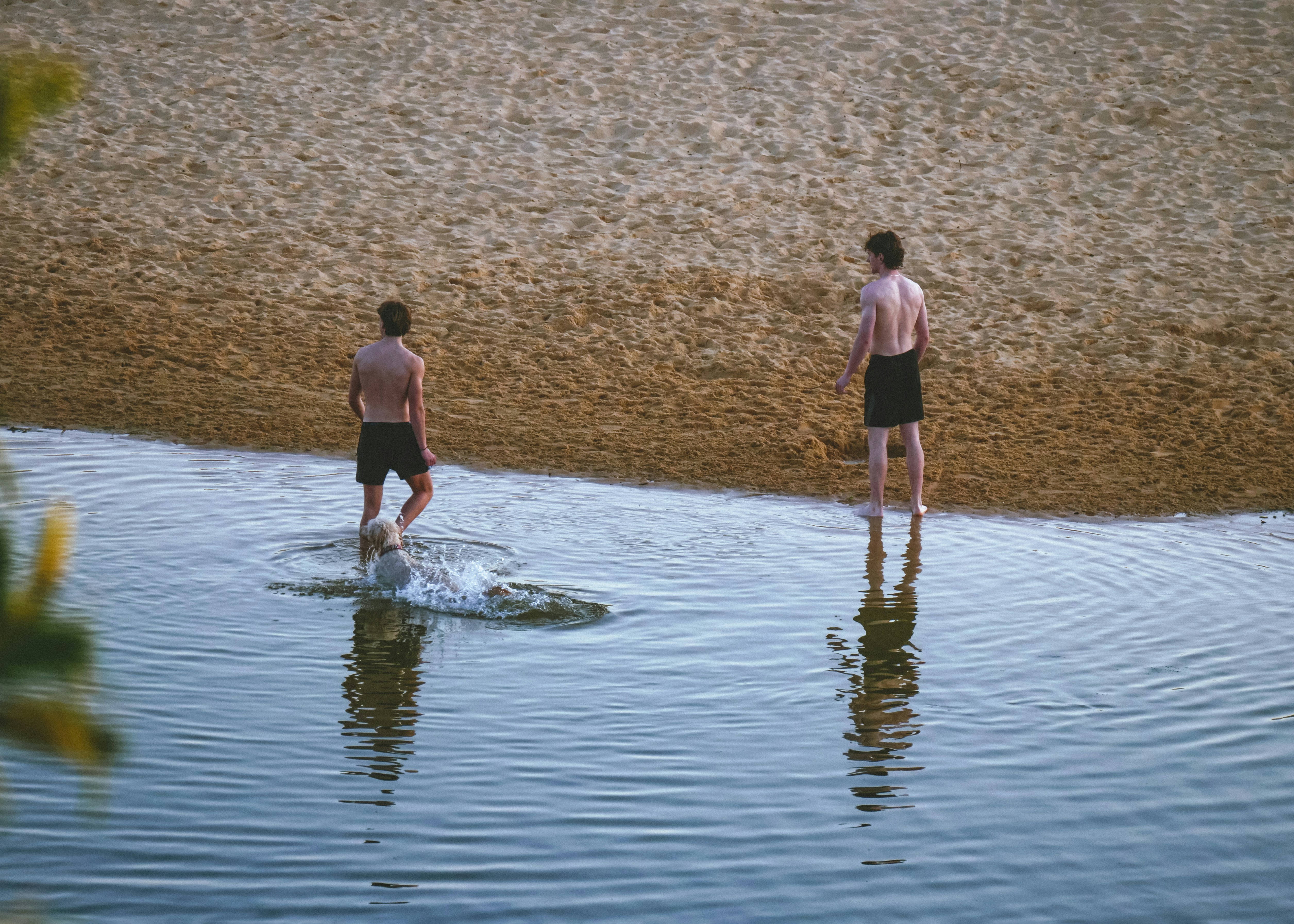 Un couple d’hommes debout au sommet d’un plan d’eau
