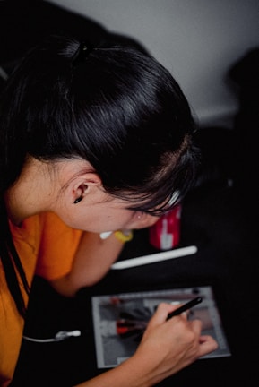 A professional smiling while working on a digital tablet, showing focus and dedication.