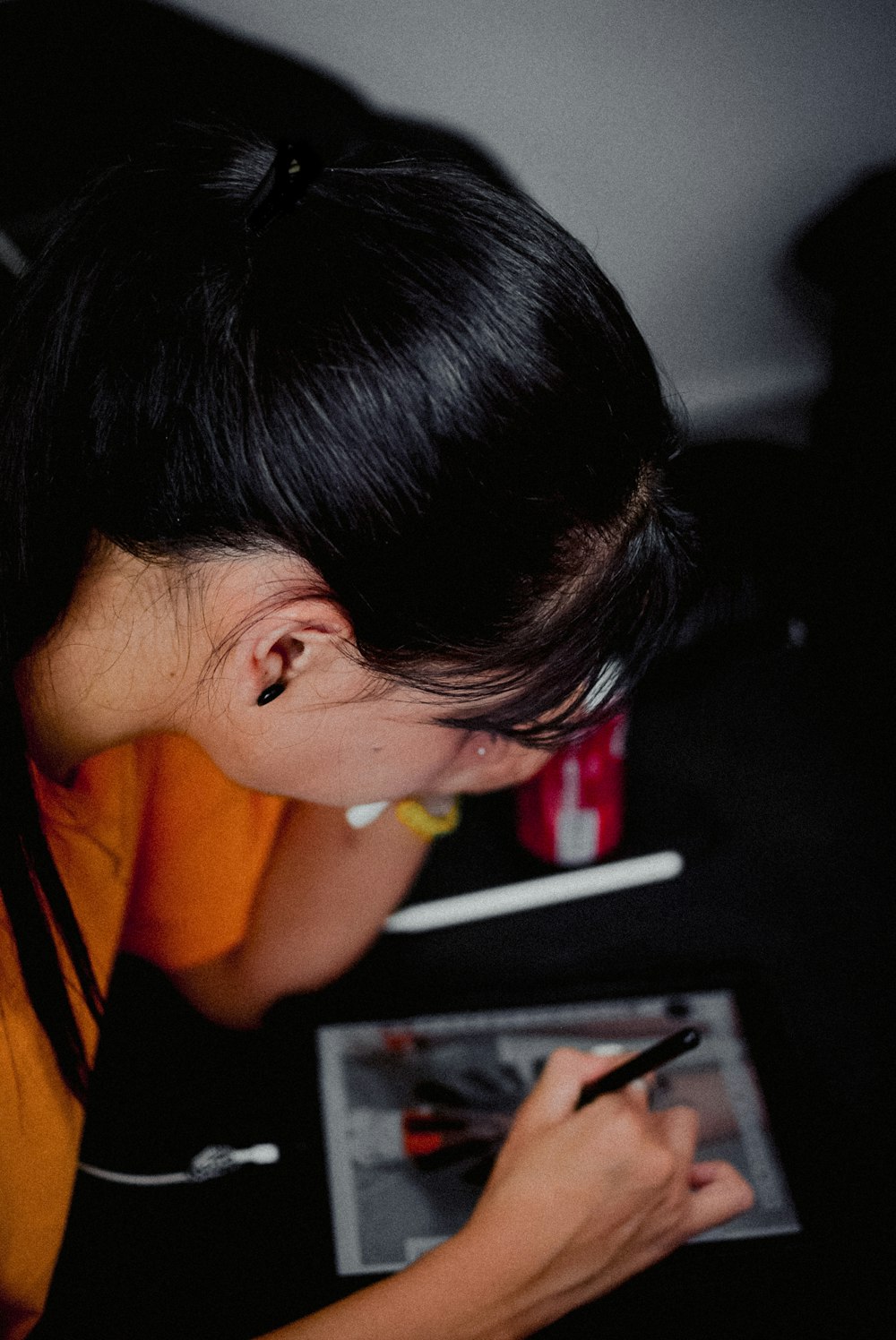 a woman writing on a piece of paper