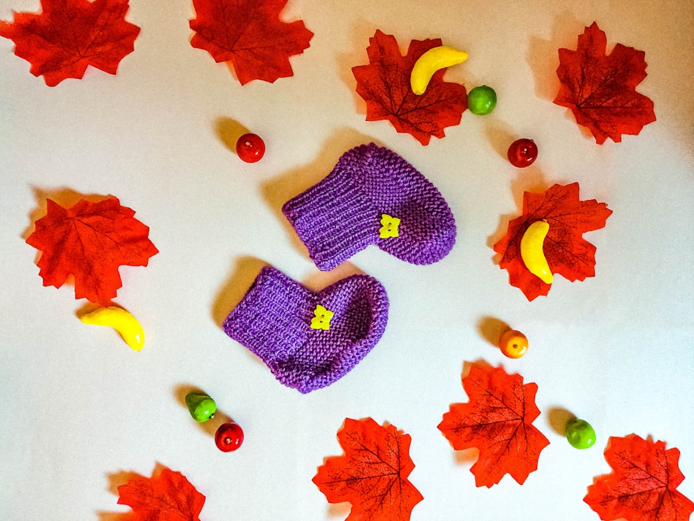 a pair of purple knitted boots sitting on top of a table