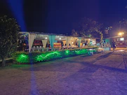 A corporate event stage with matte forest green drapes and sophisticated lighting.